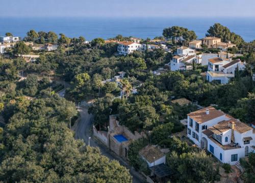 an aerial view of a small town with houses and the ocean at CASA CHAGUIMAMA Begur in Begur