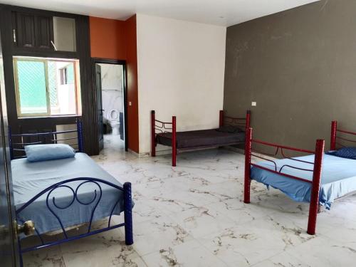 two beds in a room with a marble floor at Residencia de Lujo in Tapachula
