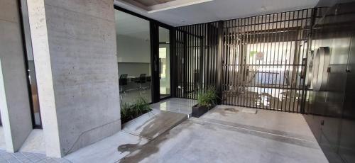 a lobby of a building with a gate and plants at Depto Zona Güemes Mdp in Mar del Plata