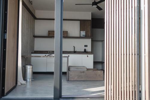 a kitchen with white cabinets and a ceiling fan at Ukino House in Nikiana