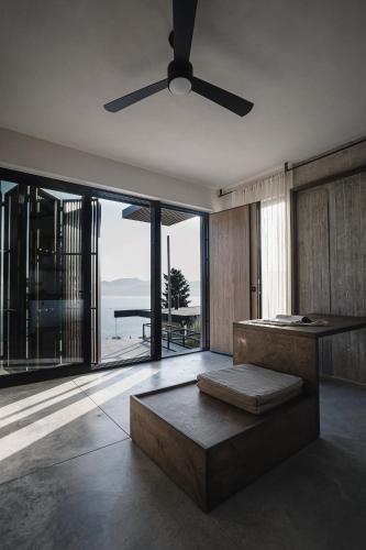 a living room with a ceiling fan and a couch at Ukino House in Nikiana