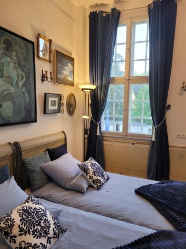 a bedroom with a bed with pillows and a window at Baroque Palais Timber House Celle in Celle