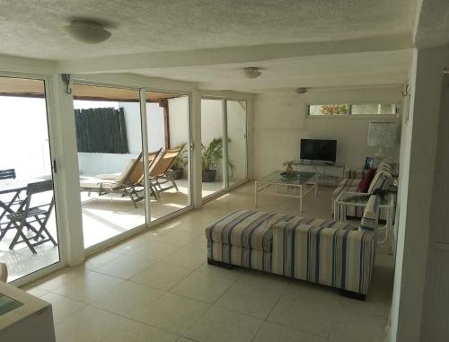 a living room with a couch and a television at Acapulco, gro Casi el Cielo in Acapulco