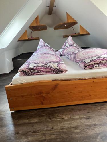 a bed with pillows on it in a room at Tinywohnung in Schluchsee