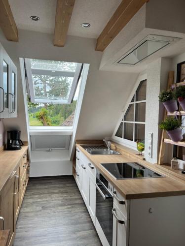a kitchen with a sink and a window at Tinywohnung in Schluchsee