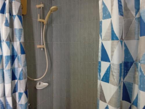 a bathroom with a shower with a shower curtain at BEN & LEK GUESTHOUSE in Pattaya South