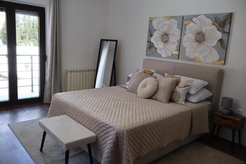 a bedroom with a bed and a table and a window at MonteMare Holiday home in Lič