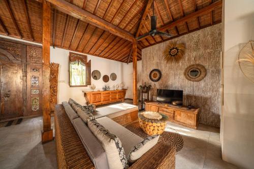 a living room with a couch and a television at 3BDR Villa with Pool Jacuzzi - Canggu in Dalung