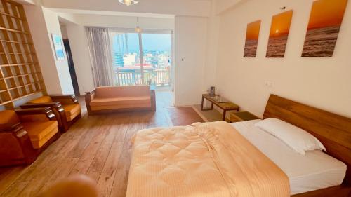 a bedroom with a bed and a chair and a window at Circle of Life in Baudhatinchule