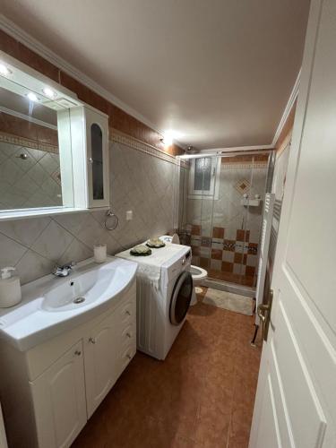 a bathroom with a sink and a washing machine at Casa Kelly Chios in Chios