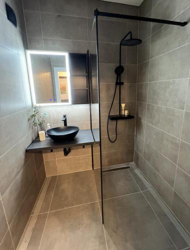 a bathroom with a sink and a shower at Friendly Space Apartment in Graz