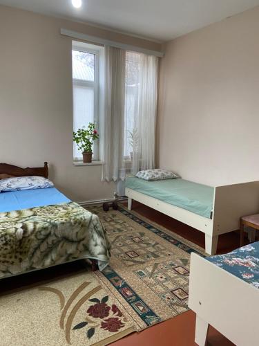 a bedroom with two beds and a window at Holiday home in Qusar