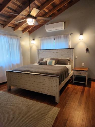 a bedroom with a large bed in a room at Cozy Yellow Cottage in Spanish Lookout