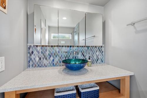 a bathroom with a blue bowl sink on a counter at Oceanfront 3BR Condo, Balcony, Fire Pit, Shared Beach, Sleeps 6 in Oceanside