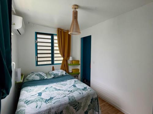 a bedroom with a bed and a window at Kaz a Ma-Lu in Le Marin