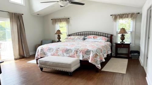 a bedroom with a large bed and a ceiling fan at Bay Breeze in Town Bank