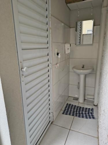 a small bathroom with a toilet and a sink at Pousada Seu Jorge in Campinas