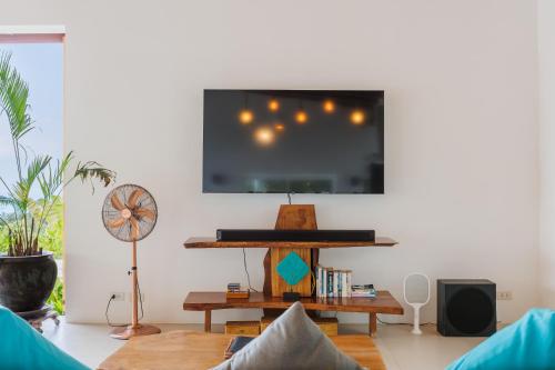 a living room with a flat screen tv on a wall at Villa Pandora in Wok Tum