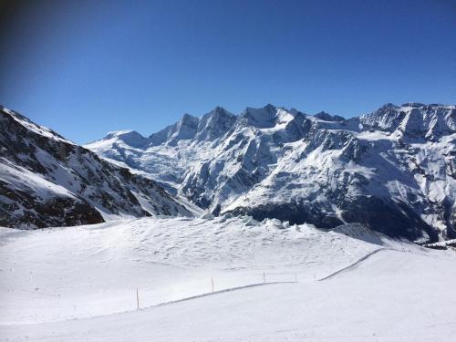 a snow covered mountain range with a ski slope at Apartments Sarazena in Saas-Grund