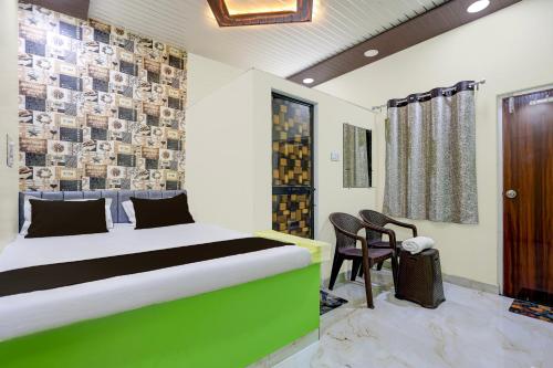 a bedroom with a bed and chairs in a room at HOTEL O GUMTHI in Māharjhari