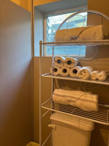 a closet with a rack with rolls and towels at The Gathering Place in Spanish Lookout