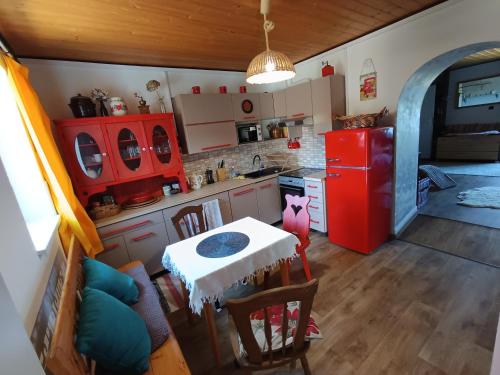 a kitchen with a table and a red refrigerator at TUTTO Home in Frýdlant nad Ostravicí