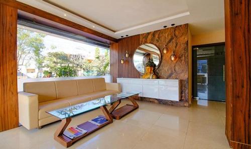 a living room with a couch and a table at Hotel Zorba in Bhopal