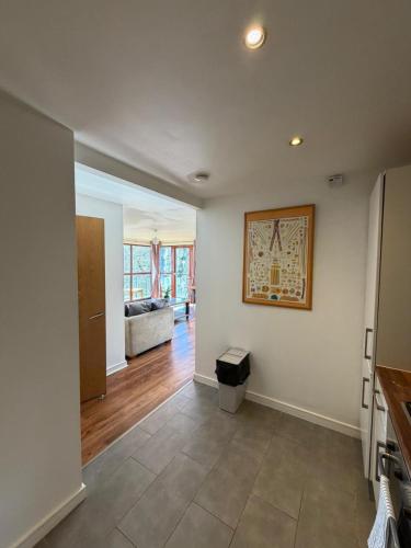 a living room with white walls and wood floors at Superb 3-Bed Residence Airport in Dublin