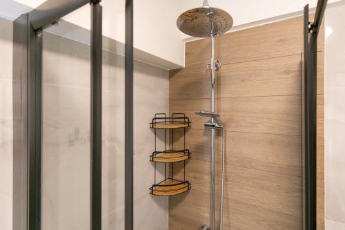 a bathroom with a shower with a glass door at Breeze Concept Villa in Drosia