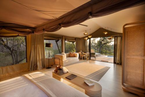 a living room with a bed and a couch and a table at 18 On The Hill in Mica