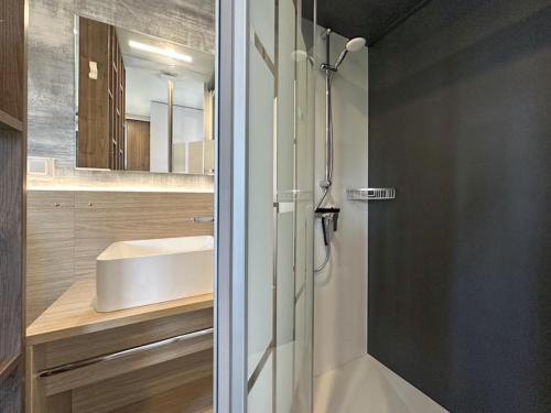 a bathroom with a shower and a sink at Feriendorf Seeblick - Tiny Chalet Nr 9 in Neunburg vorm Wald