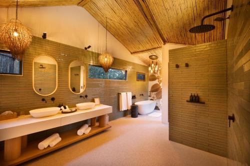 a bathroom with two sinks and two mirrors at 18 On The Hill in Mica