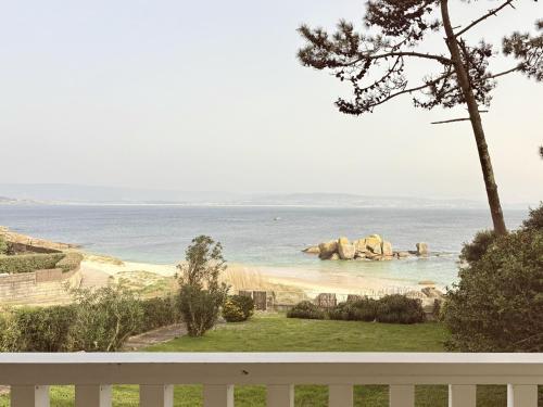 a view of the ocean from a porch at Beachfront Luxury Villa in O Grove
