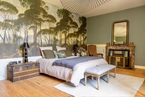 a bedroom with a large bed and a mirror at La Romanee d Or in Marchampt
