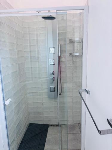 a shower with a glass door in a bathroom at Capri Horizon Hideaway in Fish Hoek