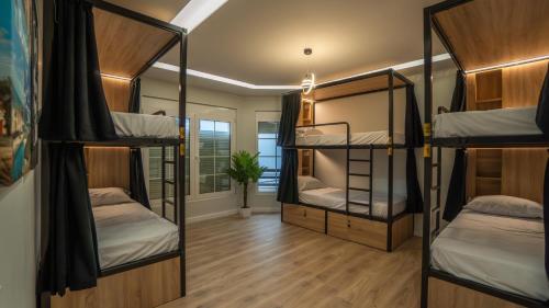 a room with four bunk beds and a hallway at 7even Boutique Hostel in Tirana