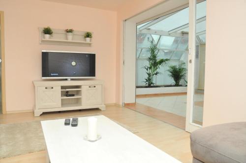 a living room with a flat screen tv on a stand at 200m² Wohnung in Walldorf - SAP in Walldorf