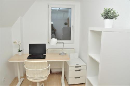 a desk with a laptop computer on it in a room at 200m² Wohnung in Walldorf - SAP in Walldorf