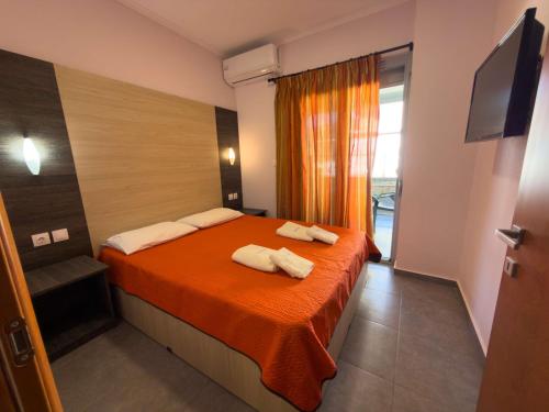 a bedroom with a bed with two towels on it at Villa Georgia beach in Neos Marmaras
