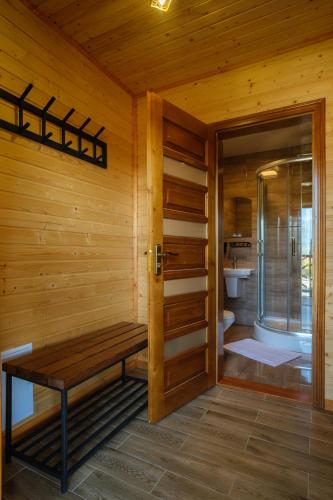 a sauna with a bench in a wooden room at Шепіт Карпат in Yasinya