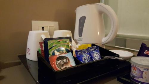 a table with a box of food and a blender at Royal Orchid Central Vadodara in Vadodara