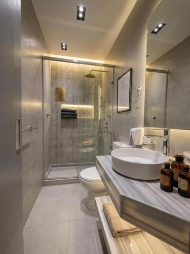 a bathroom with a sink and a toilet and a shower at The Grand Elite Cairo Hotel in Cairo