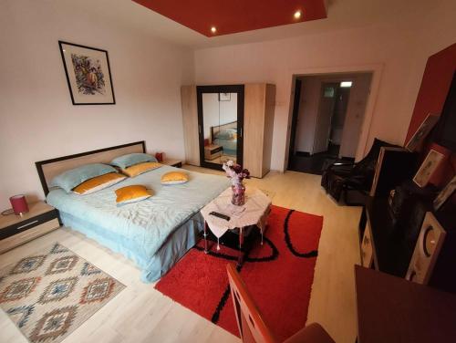 a bedroom with a large bed and a table at Apartament cu 2 dormitoare și terasa Valentin, Iulius Mall in Timişoara