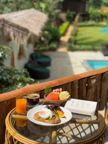 a table with a plate of food and drinks at Voasis Valley Krabi - Natural Resort - Adults Only in Ban Nong Kok (1)