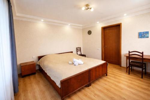 a bedroom with a bed with two white towels on it at Family hotel mountain panorama in Borjomi