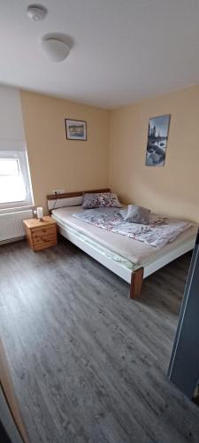 a bedroom with a large bed in a room at Ferienwohnung Rita in Aschendorf