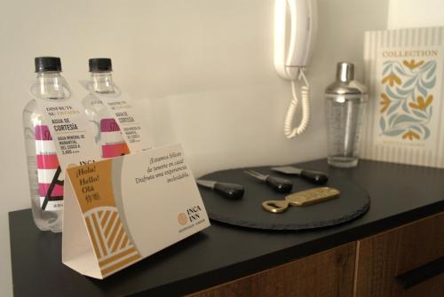 a table with a bottle of water and a phone at Inca inn apartments in Lima