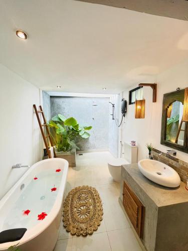 a bathroom with a bath tub and a sink at The Courtyard Villa in Sigiriya