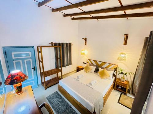 a bedroom with a bed and a blue door at The Courtyard Villa in Sigiriya