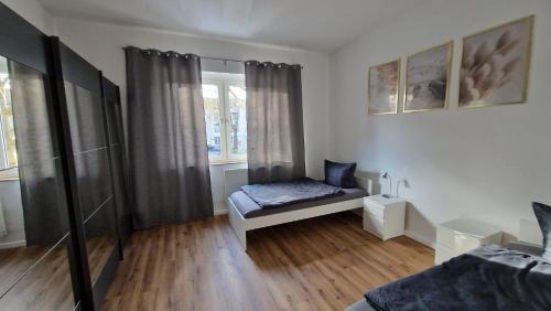 a room with a bed and a window with a bench at Viktoria's Appartment 2 in OB-Mitte in Oberhausen
